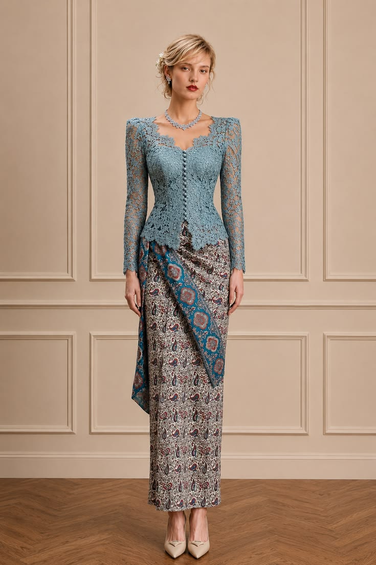 Powder-blue lace kebaya paired with multicolored batik featuring blue, ivory, rust, and burgundy details.